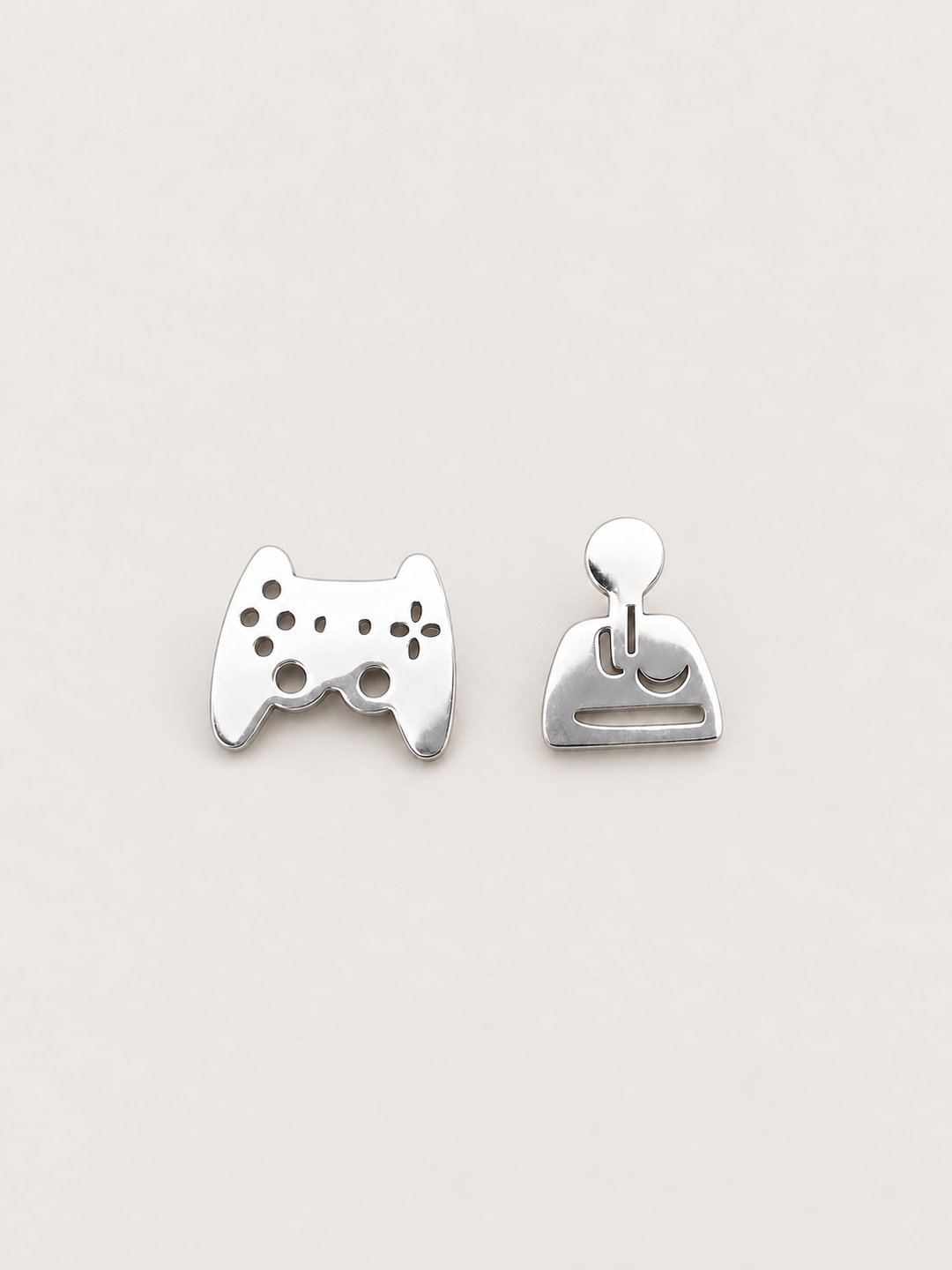 silver Game Controller and Joystick Earrings shown on a warm neutral background
