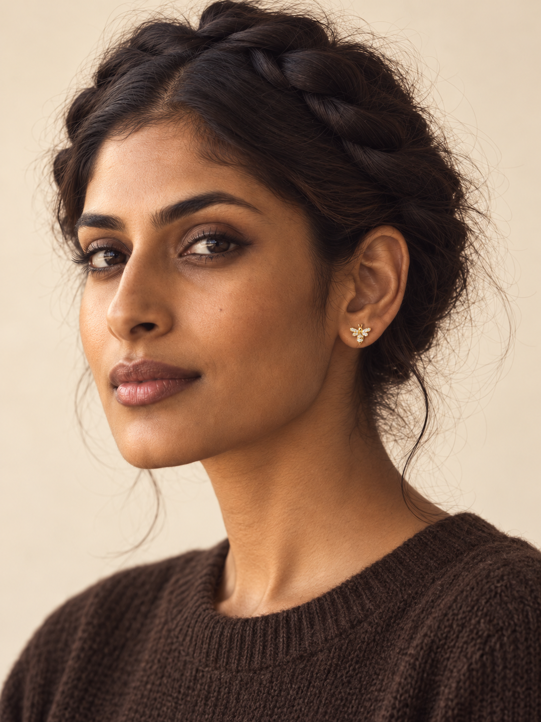 Gold Crystal Bee Stud Earrings worn on a model's viewer-right ear