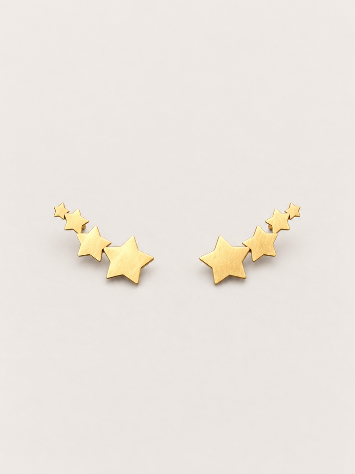 Gold Graduated Star Stud Earrings shown on a warm neutral background