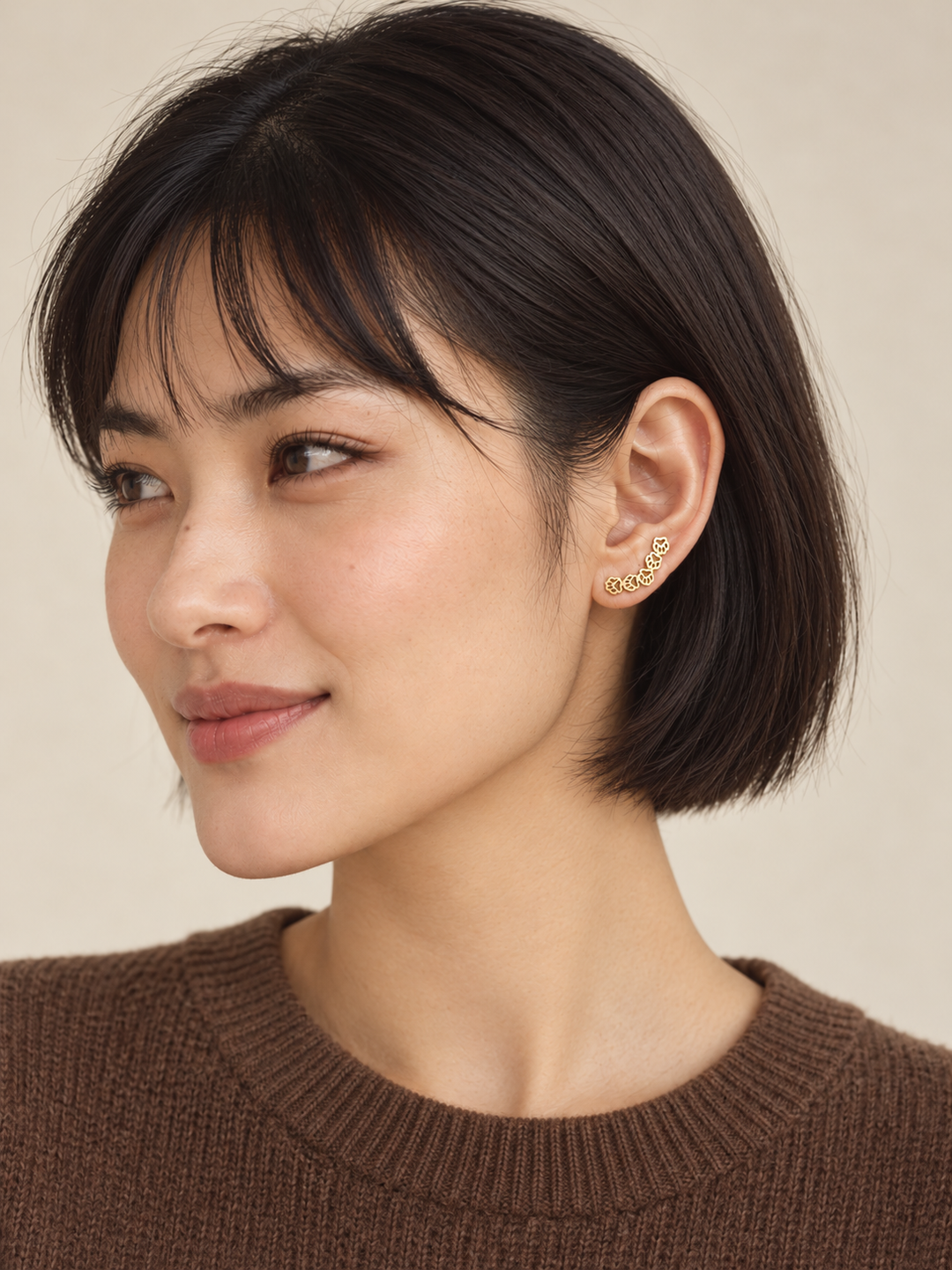 Gold Owl Ear Crawler Earrings worn on a model with a brown sweater