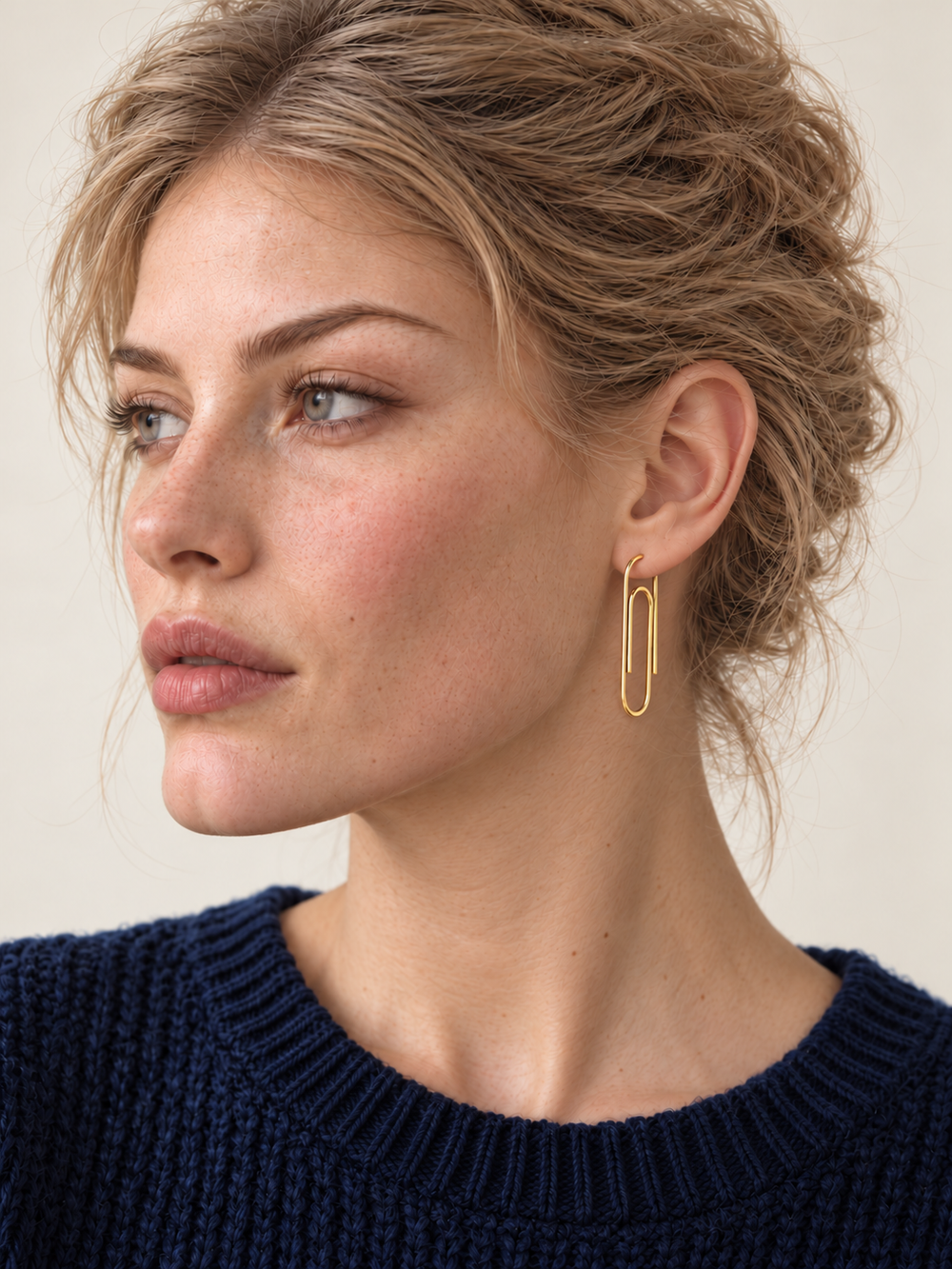 Gold Paperclip Earrings worn through an earlobe piercing