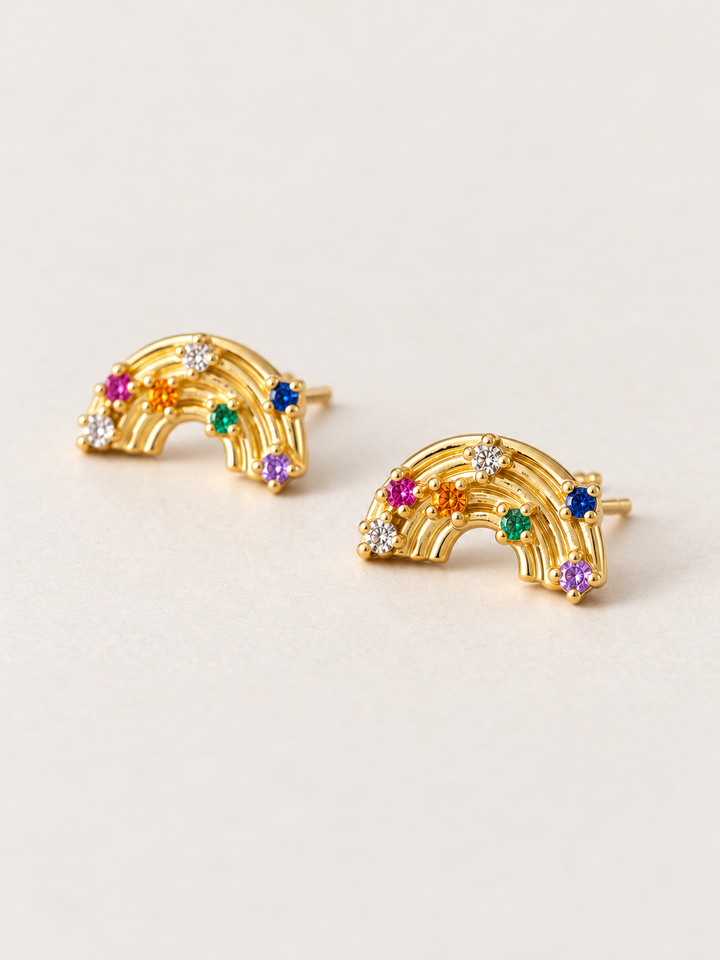 Rainbow Stud Earrings shown angled on a warm neutral background