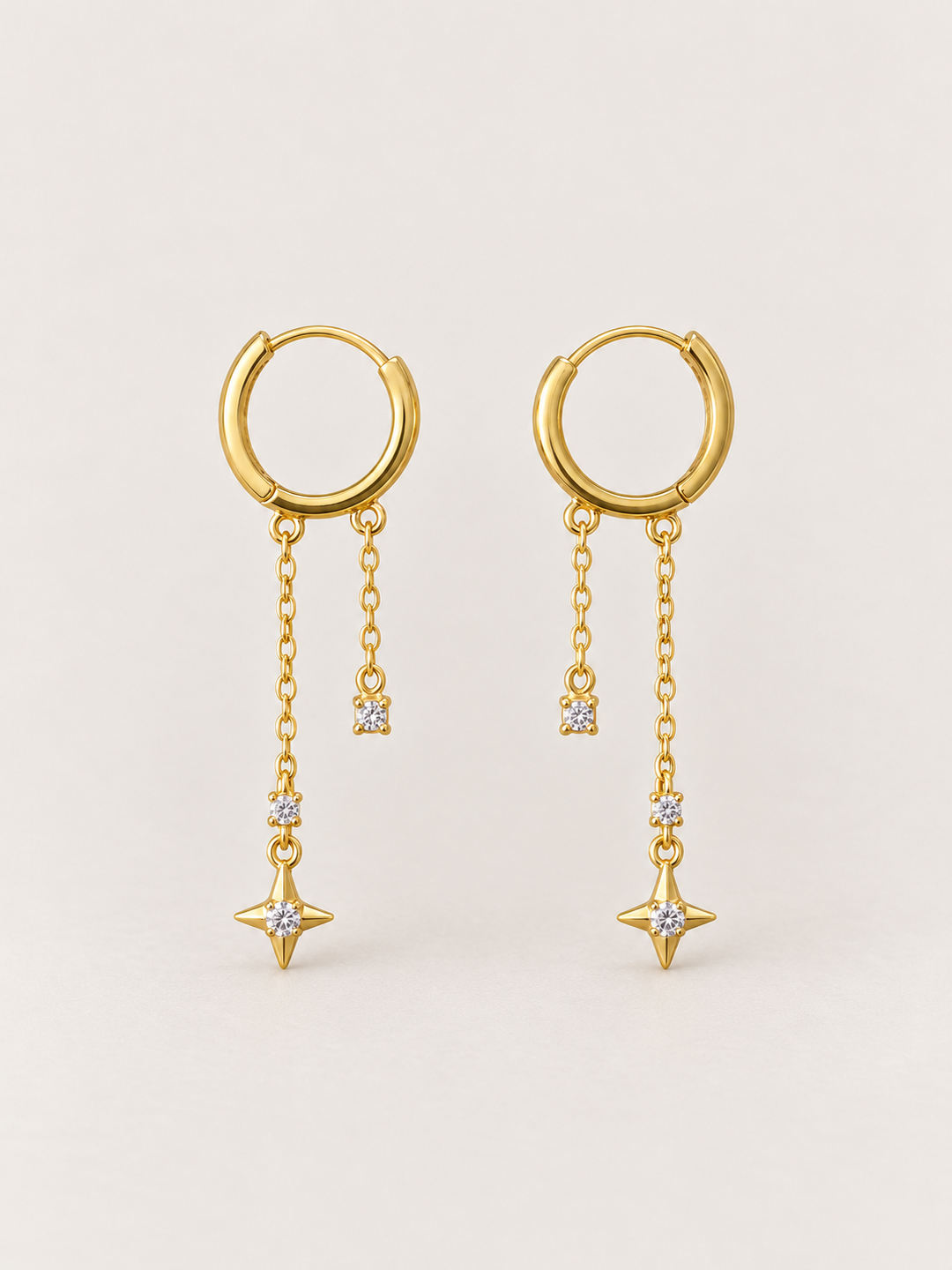 Gold Star Chain Hoop Earrings shown on a warm neutral background