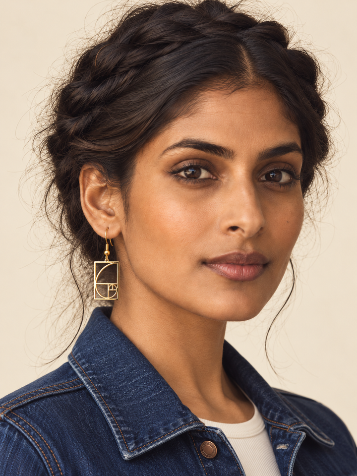 Model wearing gold Golden Ratio Spiral Drop Earrings