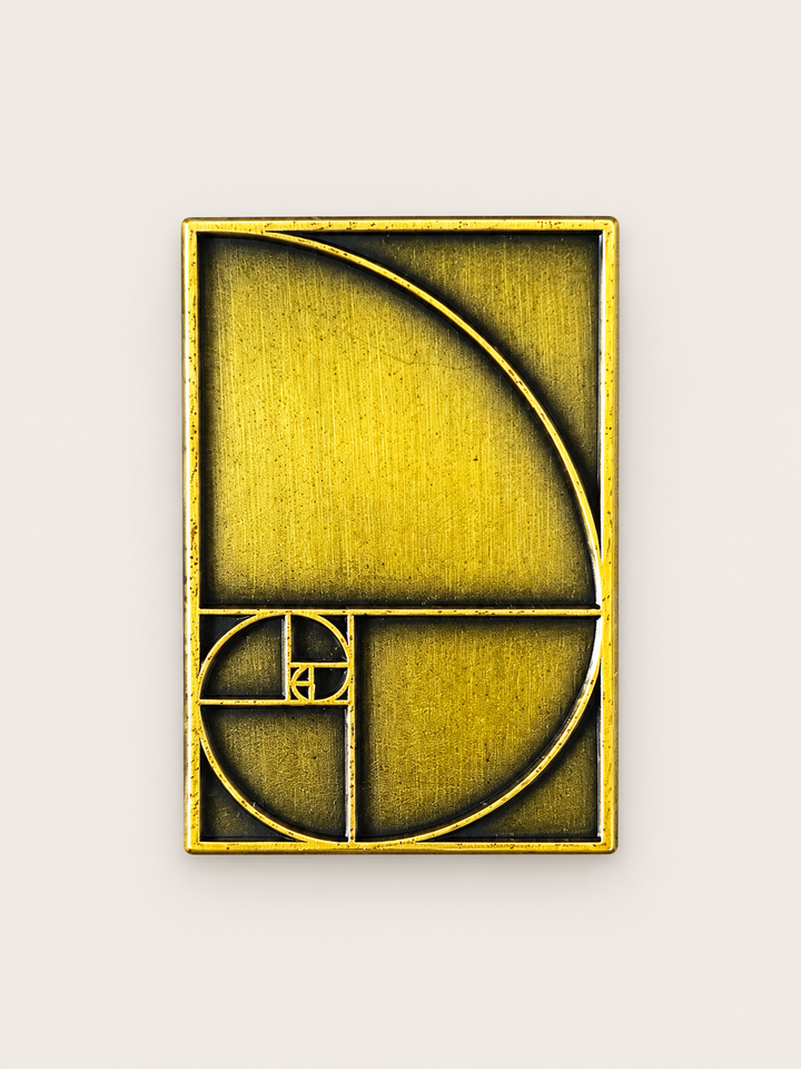Golden Ratio Spiral Pin shown on a warm neutral background