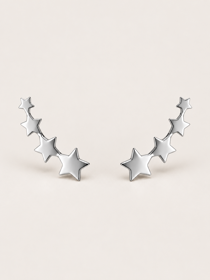 Silver Graduated Star Ear Crawler Earrings shown on a warm neutral background