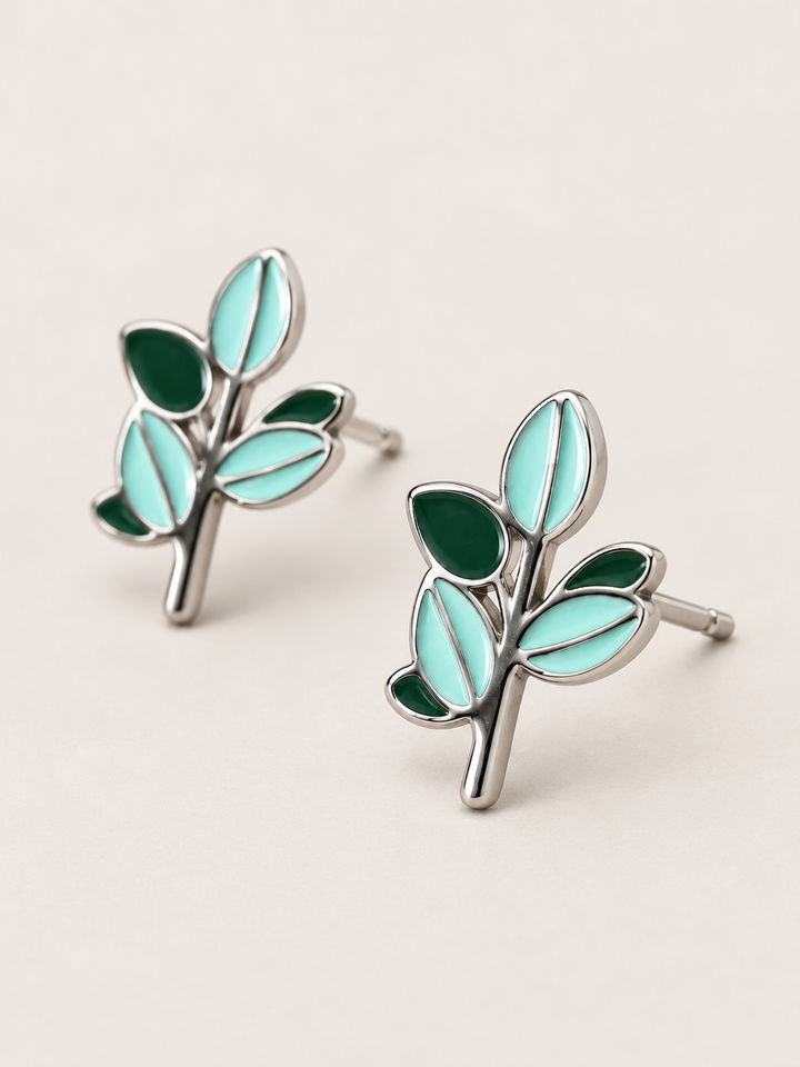 Green Leaf Stud Earrings shown angled on a warm neutral background