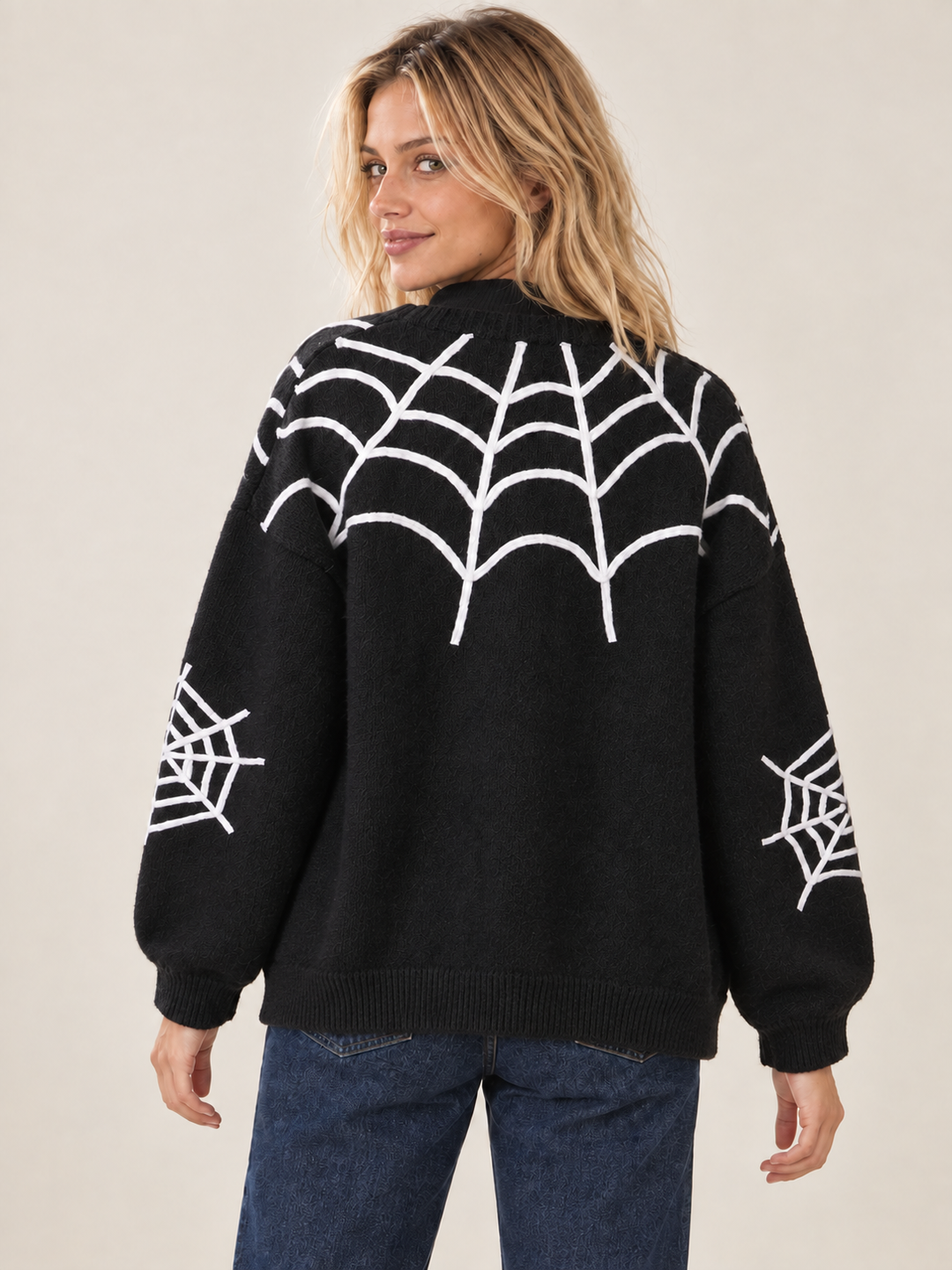 Back view of black Halloween cardigan with white spiderweb design