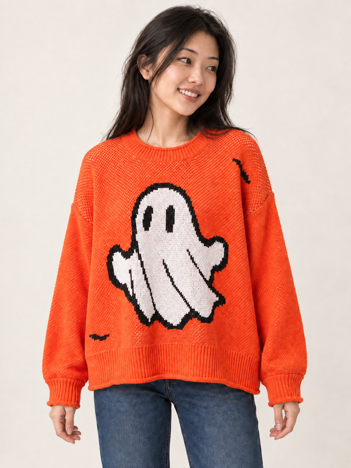 Front view of oversized orange Halloween ghost sweater on model