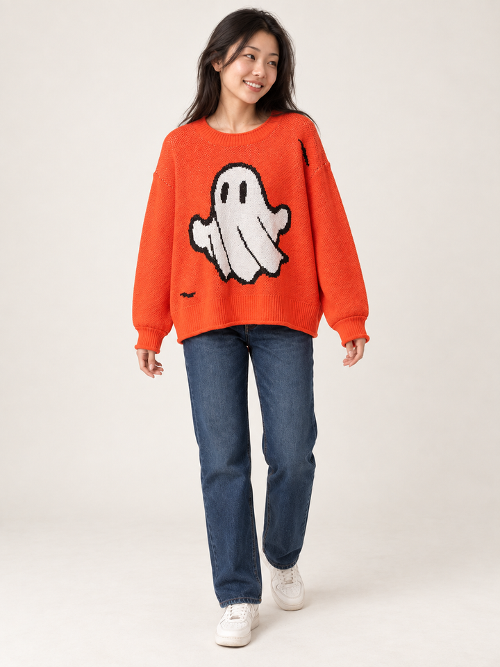 Full body view of model wearing oversized orange ghost sweater and dark indigo jeans