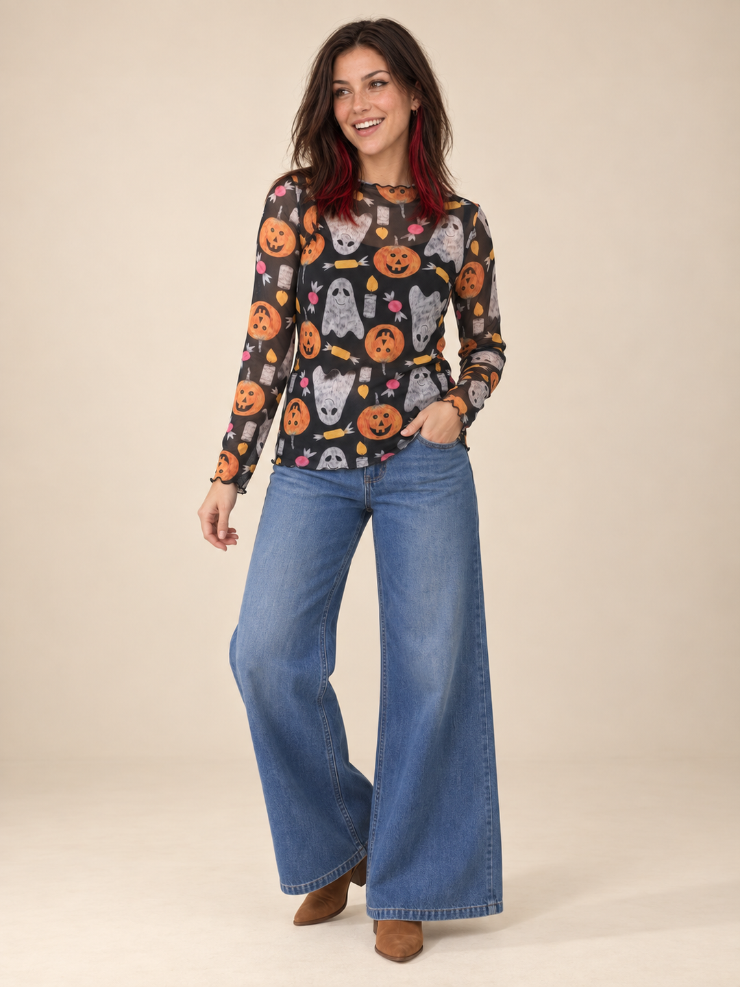 Model wearing Halloween sheer long sleeve spooky top, full-body view