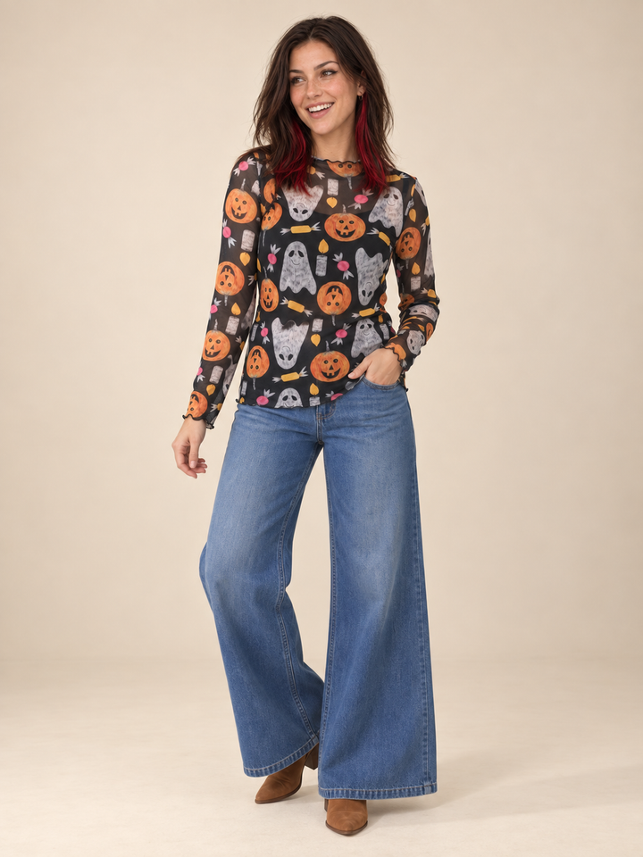 Model wearing Halloween sheer long sleeve spooky top, full-body view