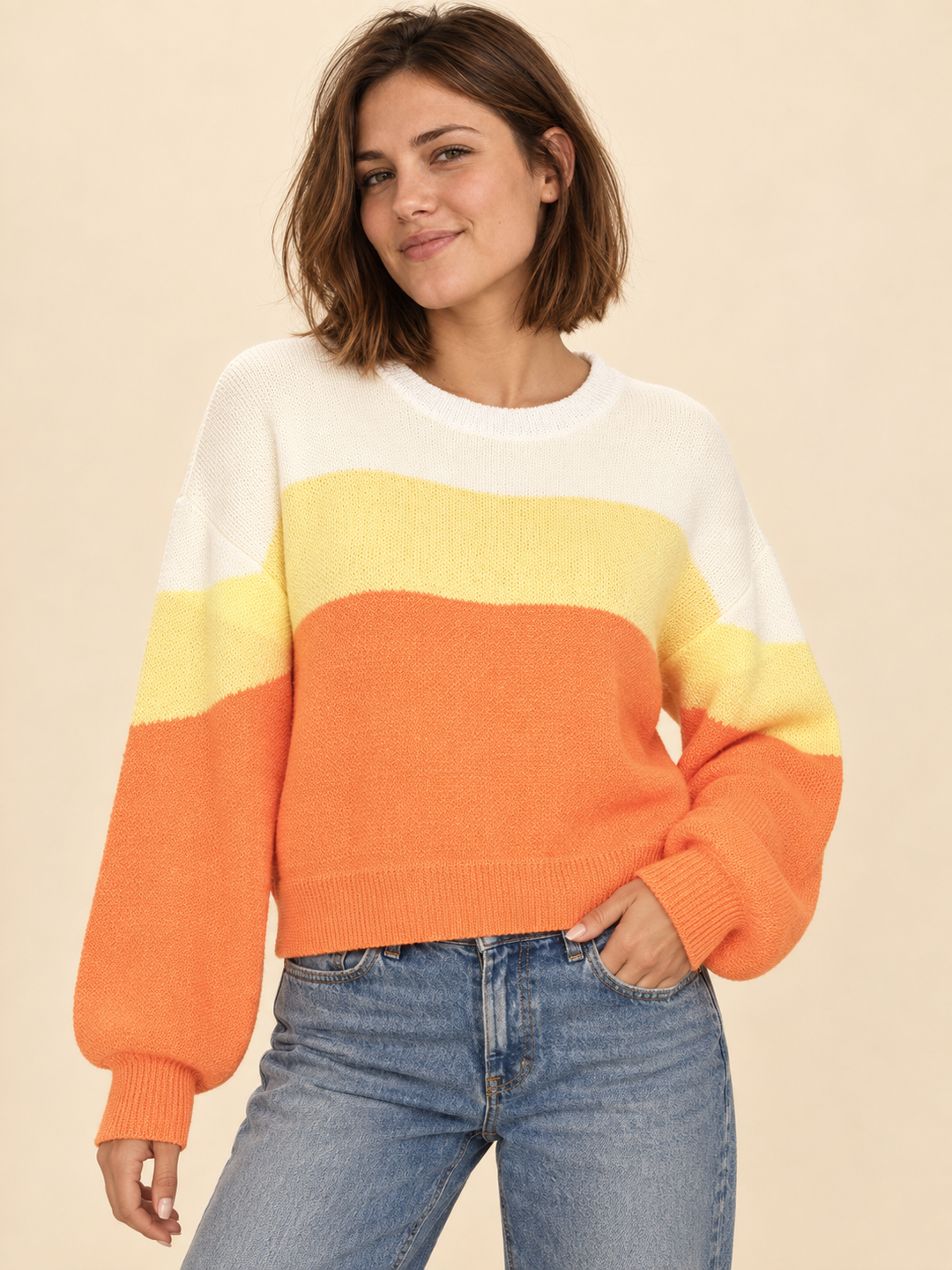 Model wearing Halloween candy corn striped sweater, front view