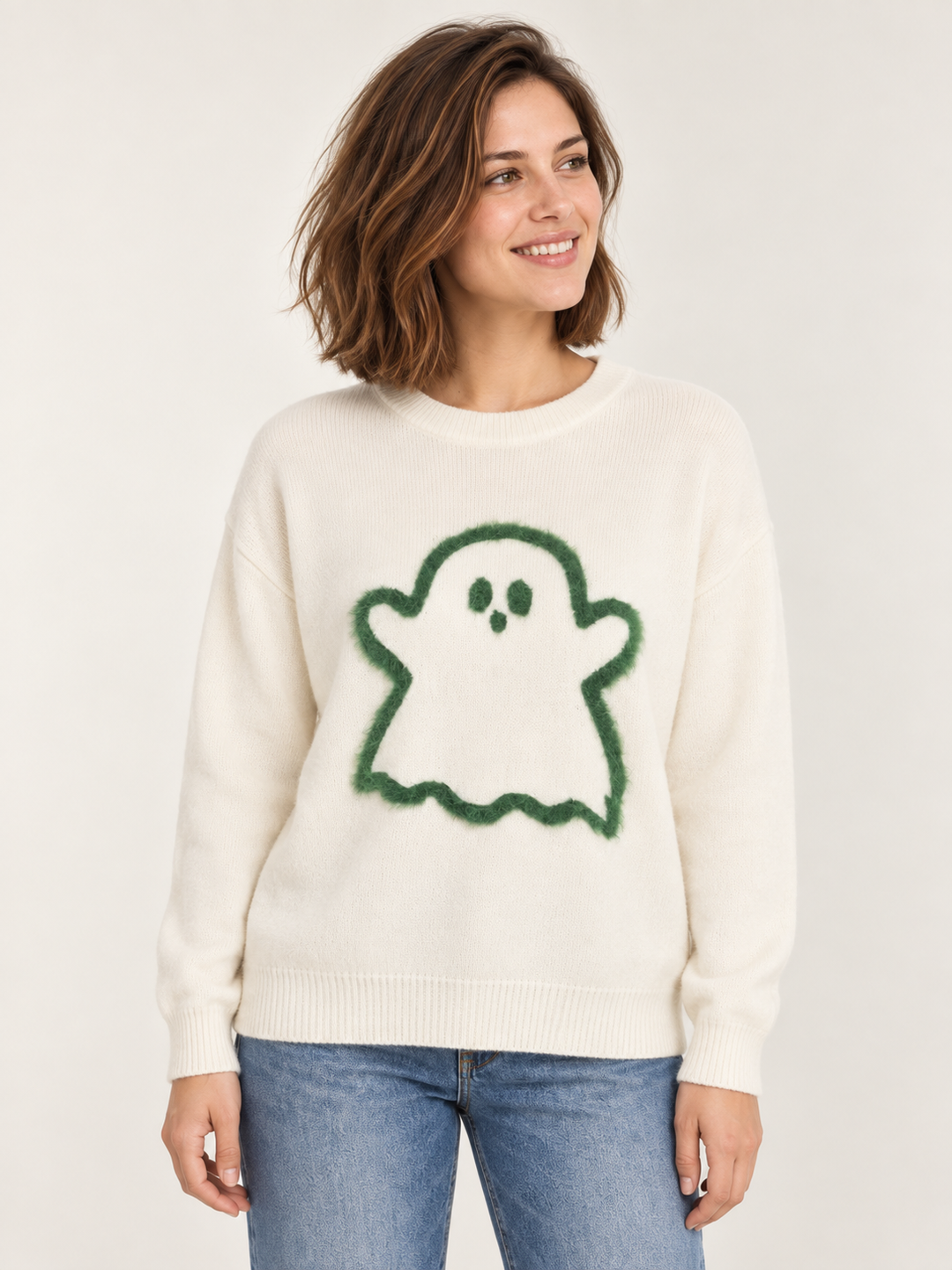 Ivory sweater with fuzzy green ghost design, front view on model