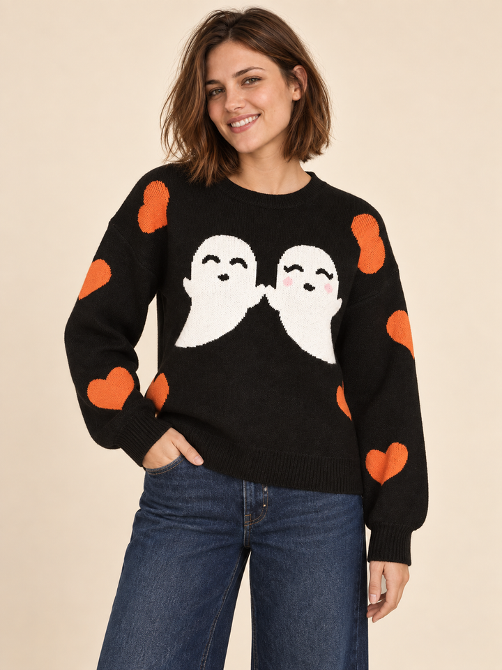 Black Halloween sweater with white ghosts and orange hearts, front view on model