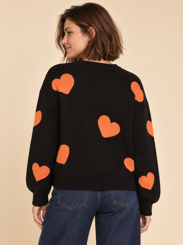 Black Halloween sweater with white ghosts and orange hearts, back view on model