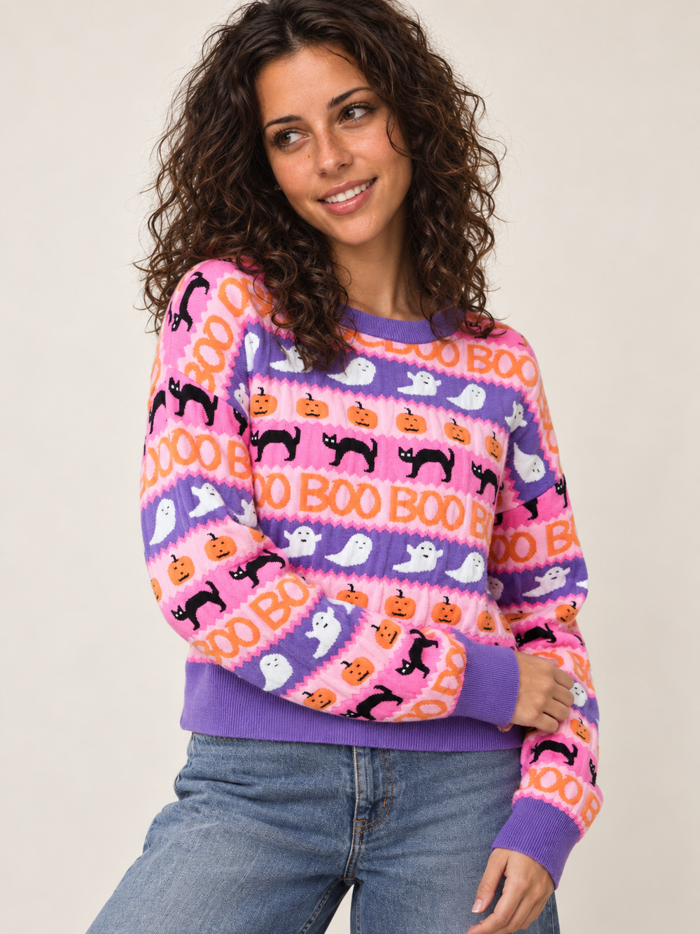 Model wearing Halloween Sweater Pink Purple Stripes Boo Ghost Cat, angled view