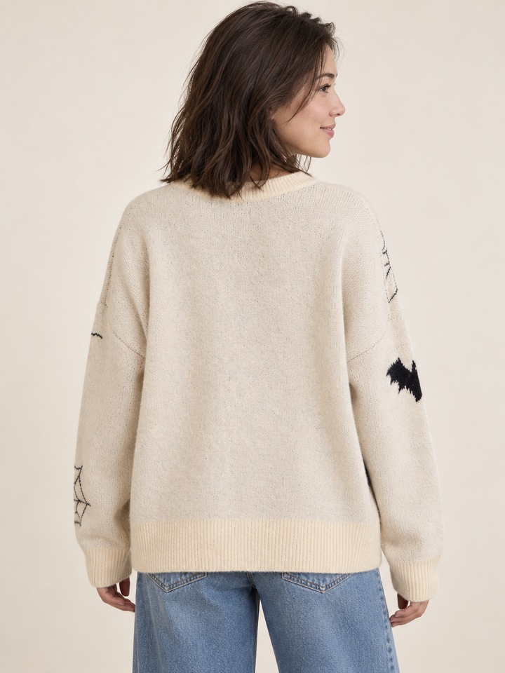 Cream pumpkin and bat Halloween sweater, back view on model