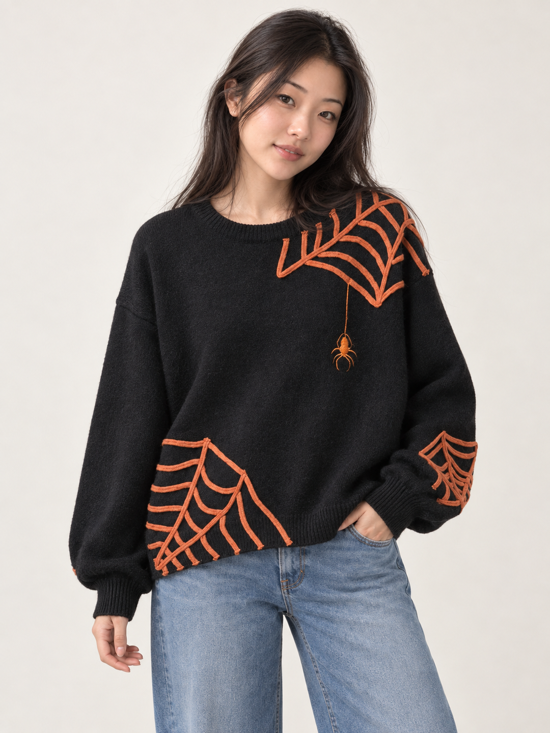 Model wearing Halloween spider applique sweater, front view