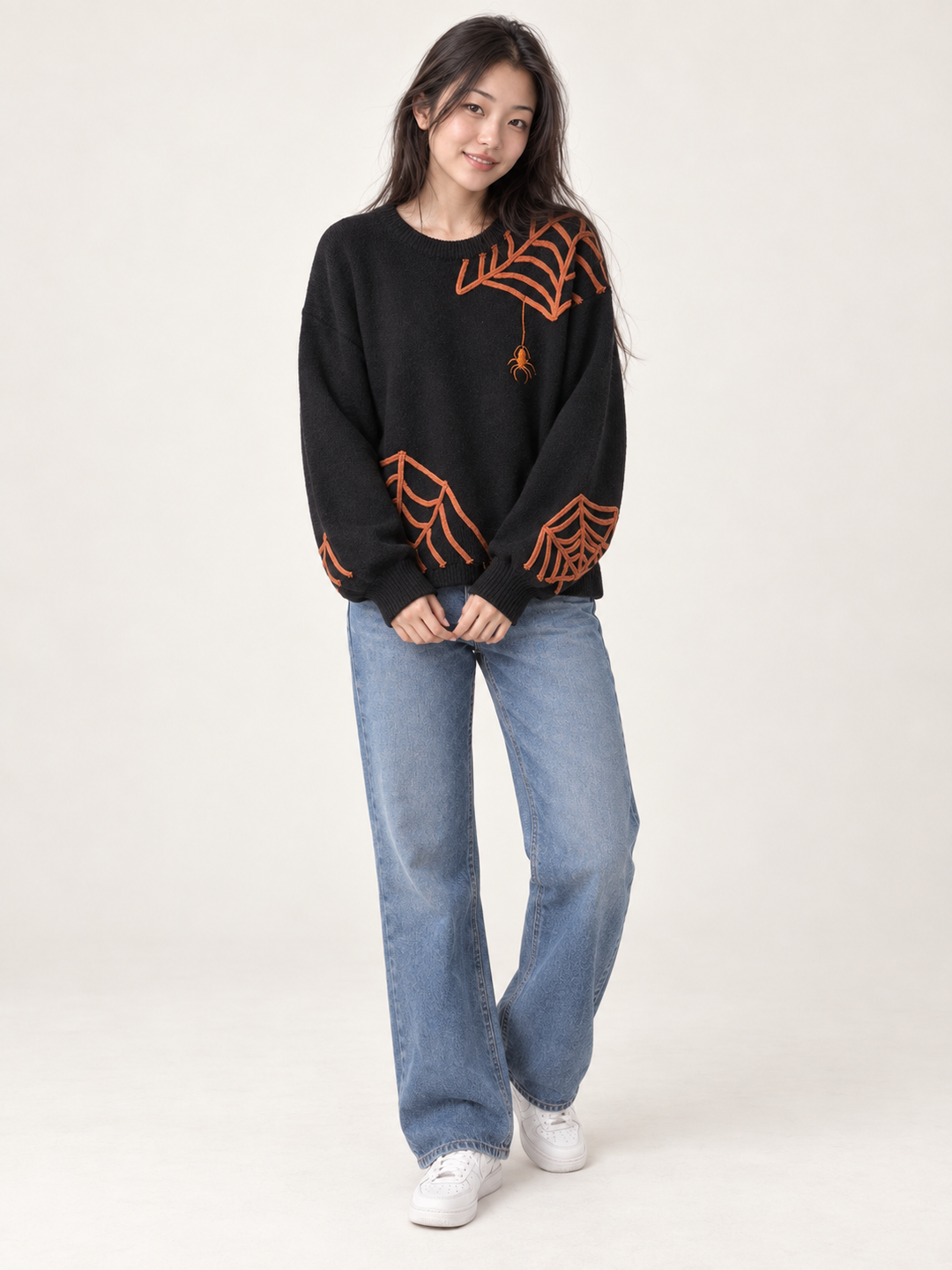 Model wearing Halloween spider applique sweater, full body view