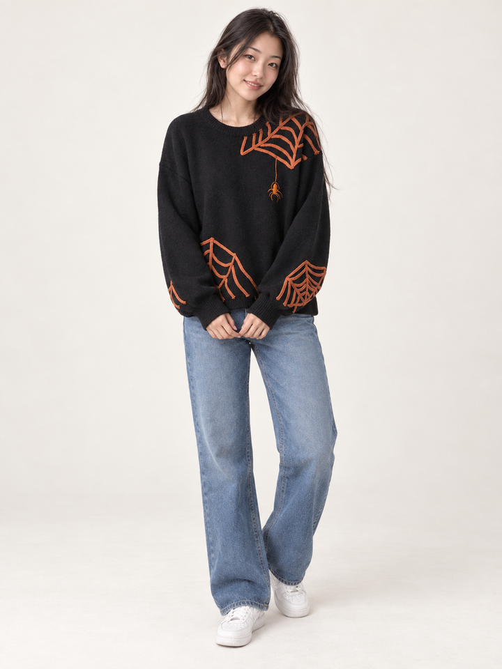Model wearing Halloween spider applique sweater, full body view