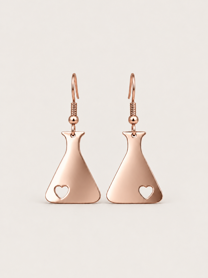 Rose Gold Heart Flask Drop Earrings on a warm neutral background