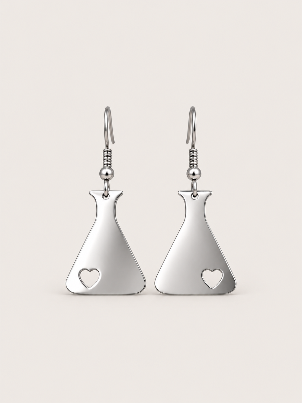 Silver Heart Flask Drop Earrings on a warm neutral background