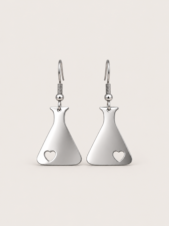 Silver Heart Flask Drop Earrings on a warm neutral background