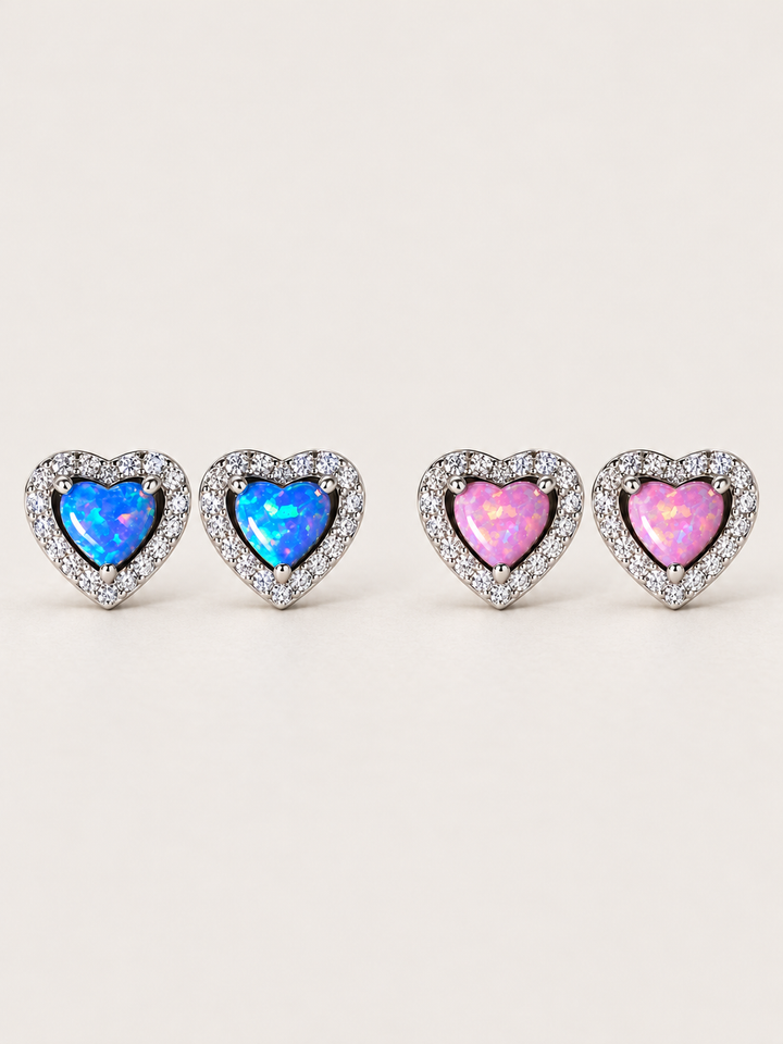 Heart Halo Stud Earrings in Blue and Pink sterling silver shown on a warm neutral background
