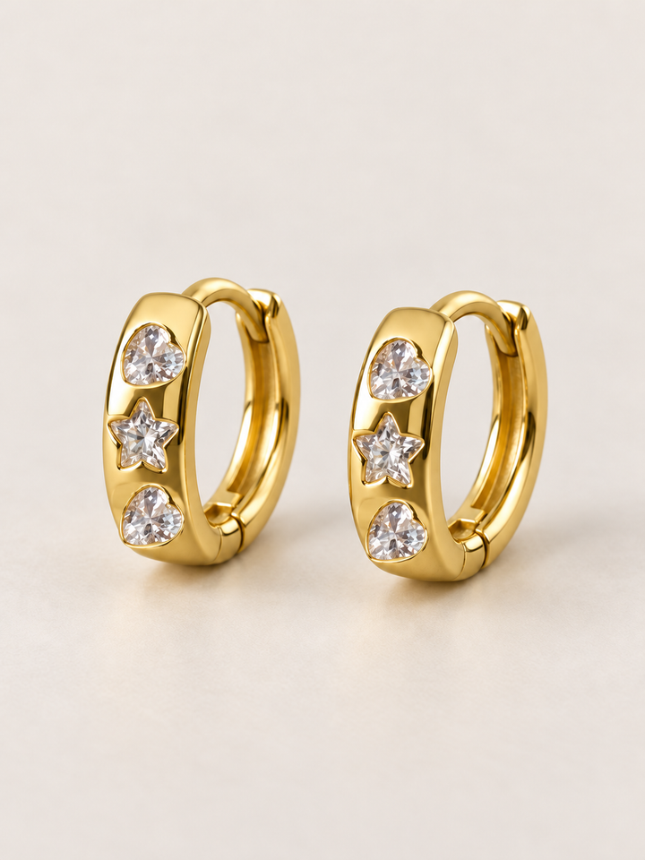 Heart and Star Huggie Earrings shown on a warm neutral background