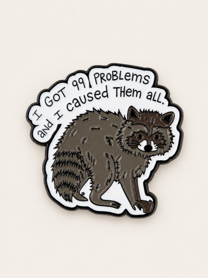 I Got 99 Problems Raccoon Pin shown on a warm neutral background