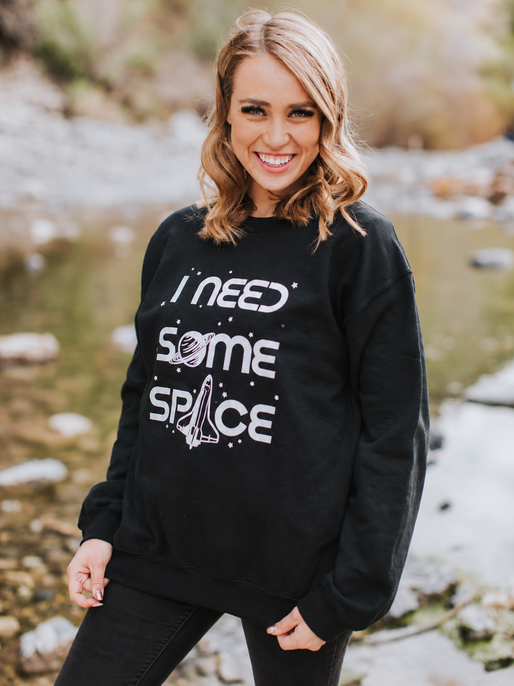 Model wearing black I Need Some Space sweatshirt