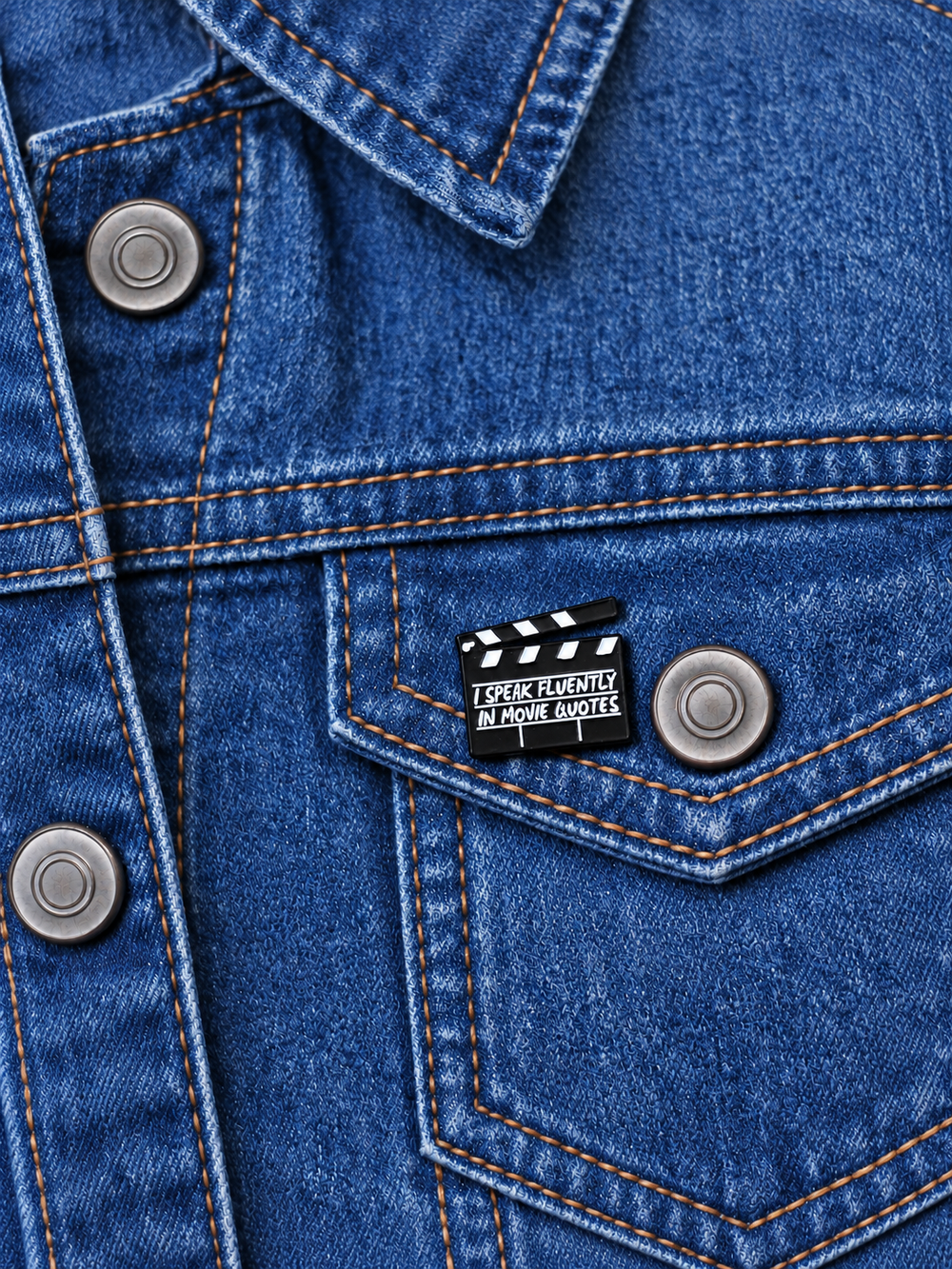 I Speak Fluently in Movie Quotes Pin displayed on a denim jacket beside a metal button