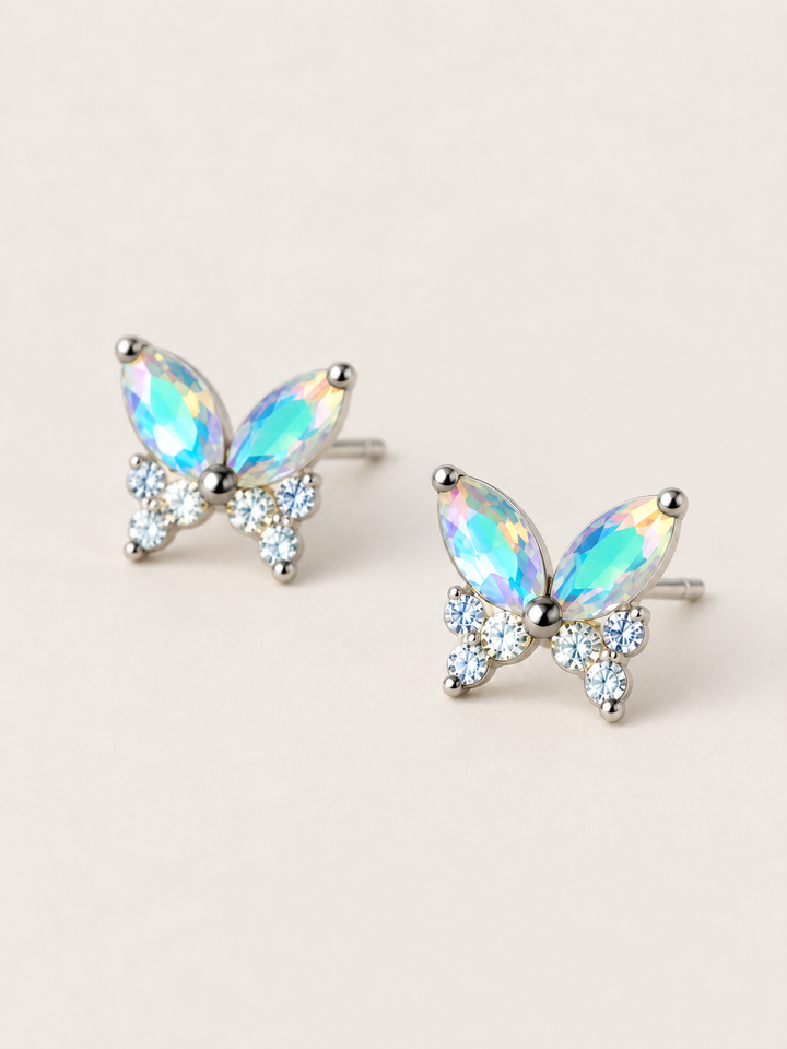 Iridescent Butterfly Stud Earrings shown angled on a warm neutral background