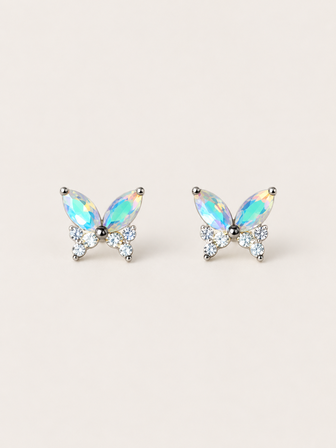 Iridescent Butterfly Stud Earrings shown on a warm neutral background