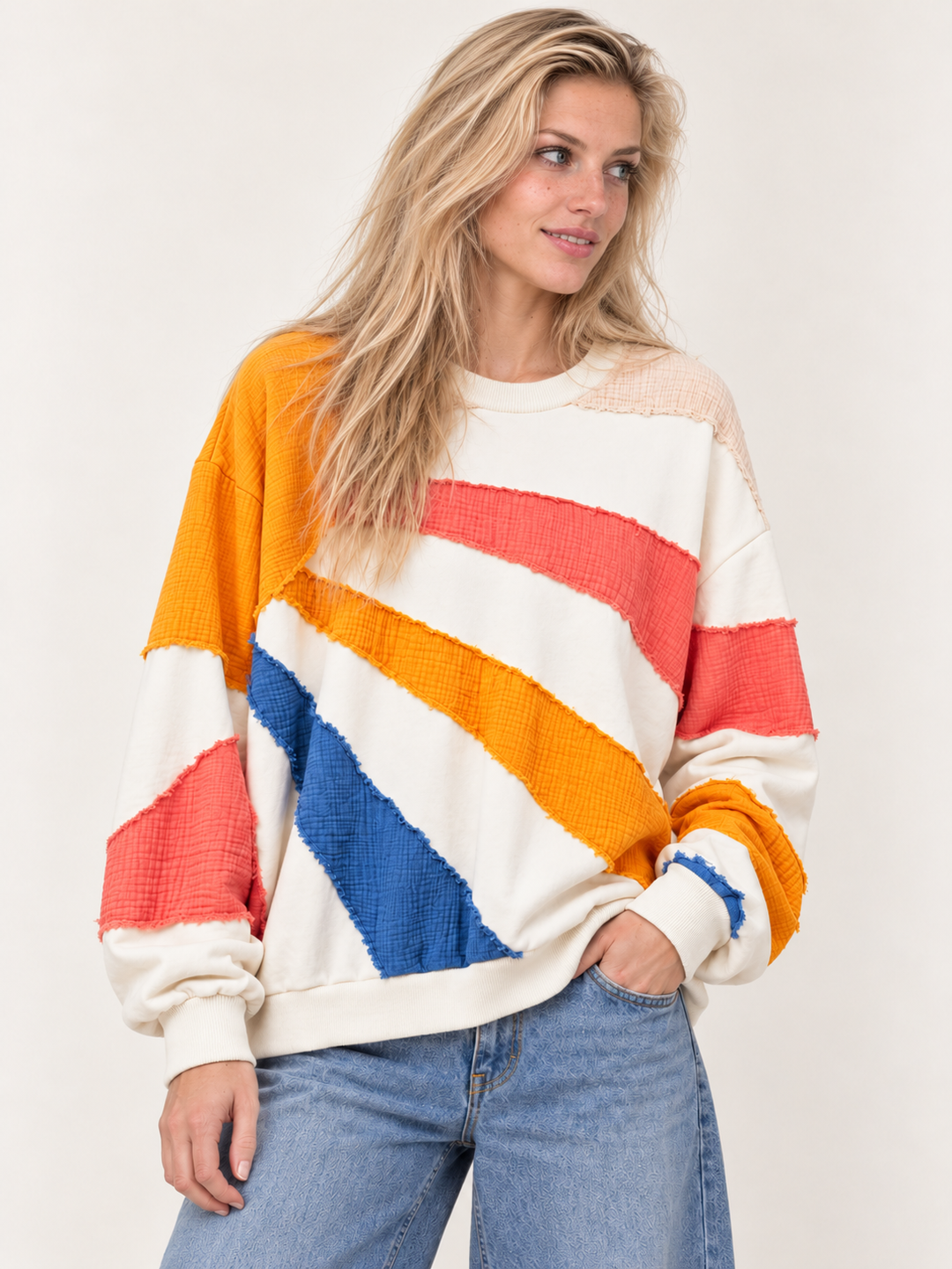 Front view of ivory oversized sun rays patchwork sweatshirt
