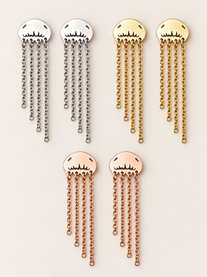 Jellyfish Chain Drop Earrings in Silver, Gold and Rose Gold on a warm neutral background