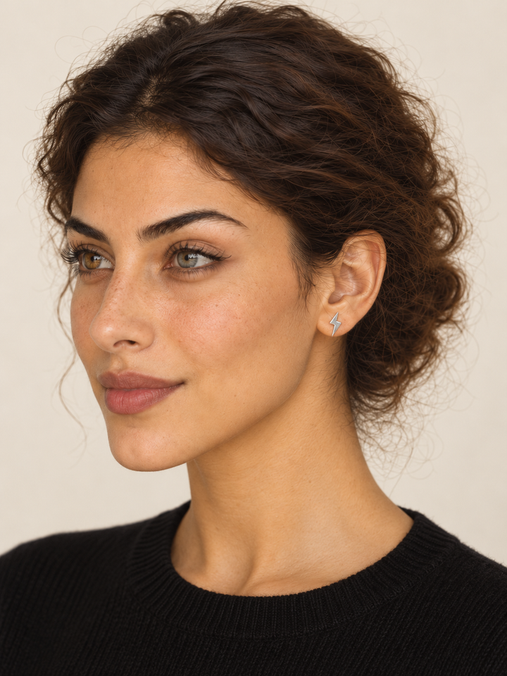 Silver Lightning Bolt Earrings worn on the viewer-right ear