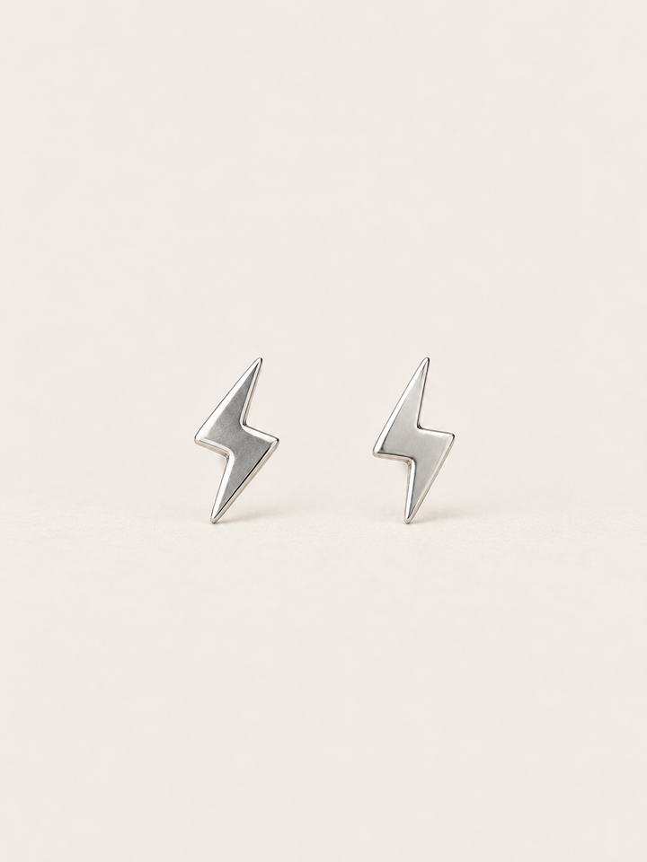 Silver Lightning Bolt Earrings on a warm neutral background