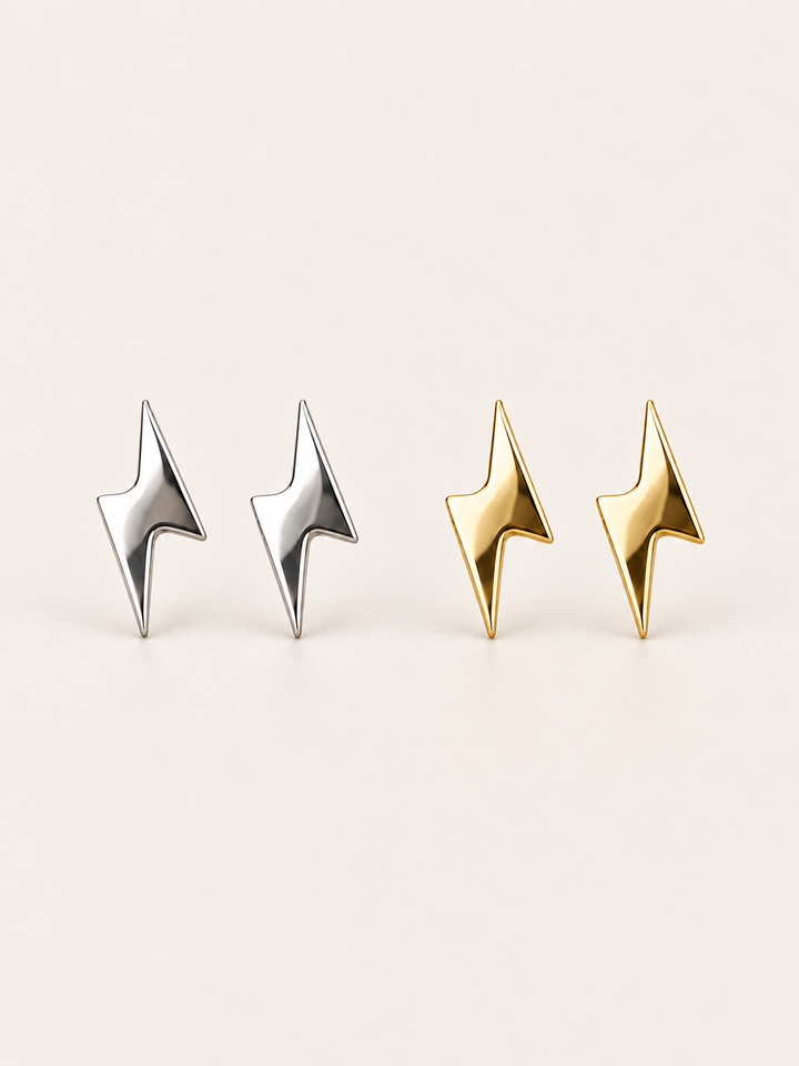 Silver and gold Lightning Bolt Stud Earrings shown on a warm neutral background