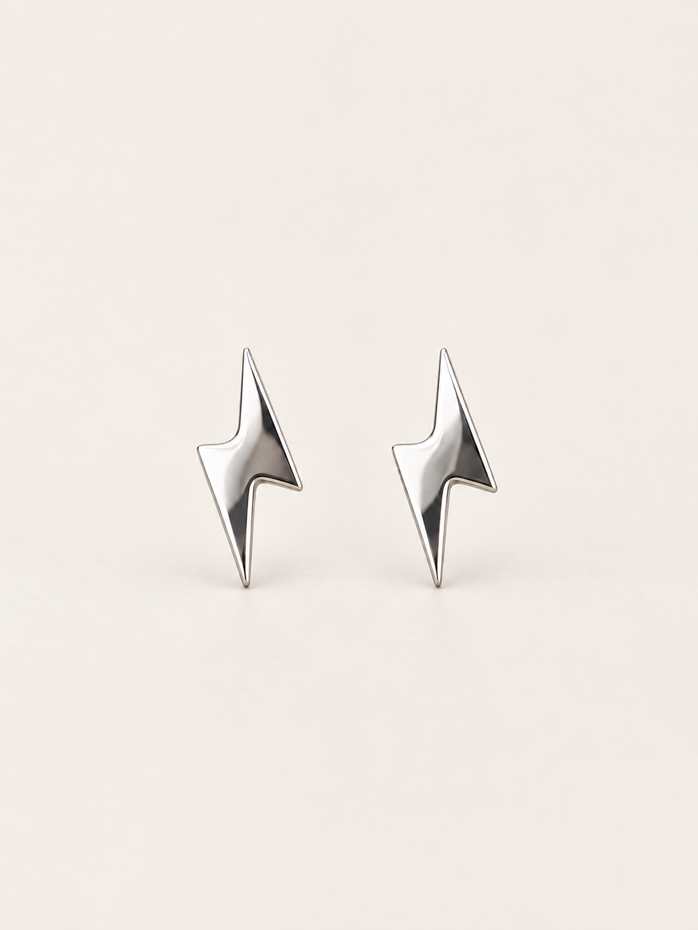 Silver Lightning Bolt Stud Earrings shown on a warm neutral background