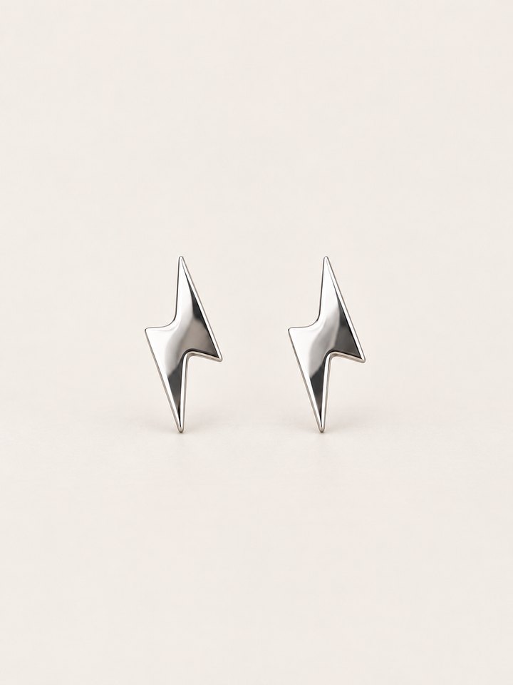 Silver Lightning Bolt Stud Earrings shown on a warm neutral background