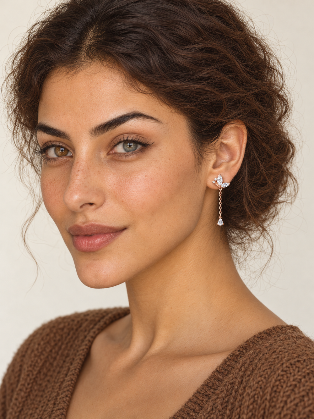 Model wearing rose gold Marquise Crystal Chain Drop Earrings on the viewer-right ear