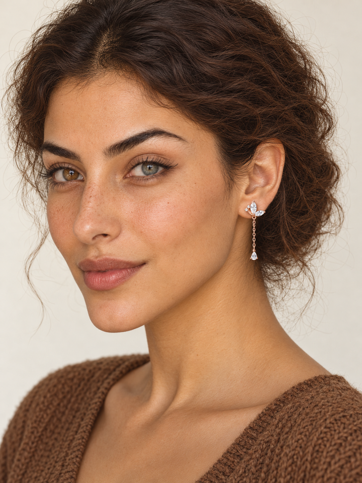 Model wearing rose gold Marquise Crystal Chain Drop Earrings on the viewer-right ear