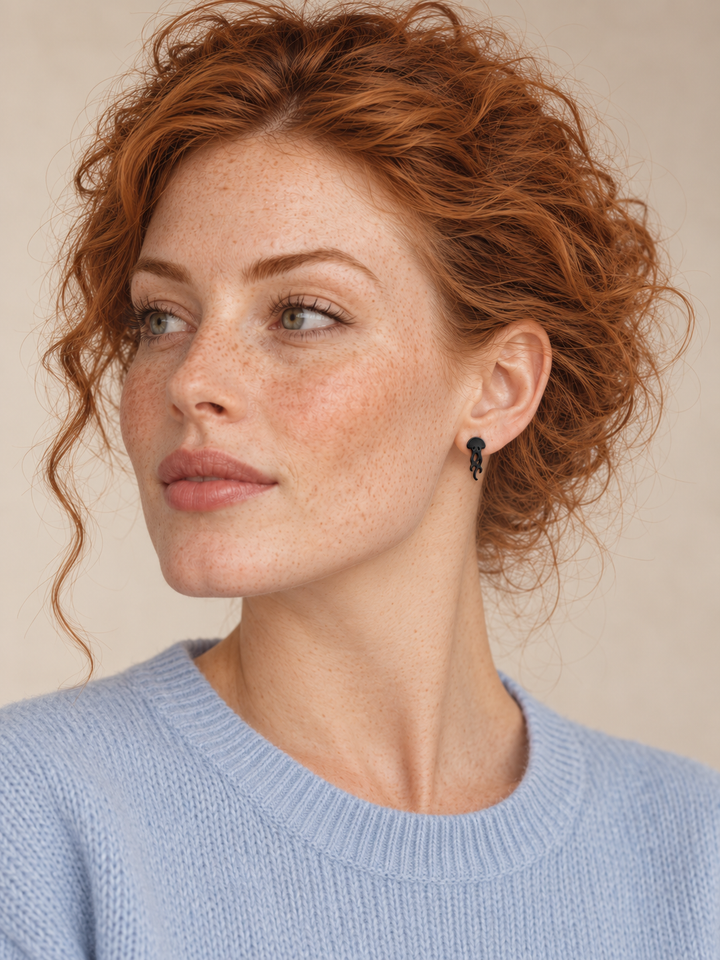 Black Jellyfish Stud Earrings worn on a model's viewer-right ear