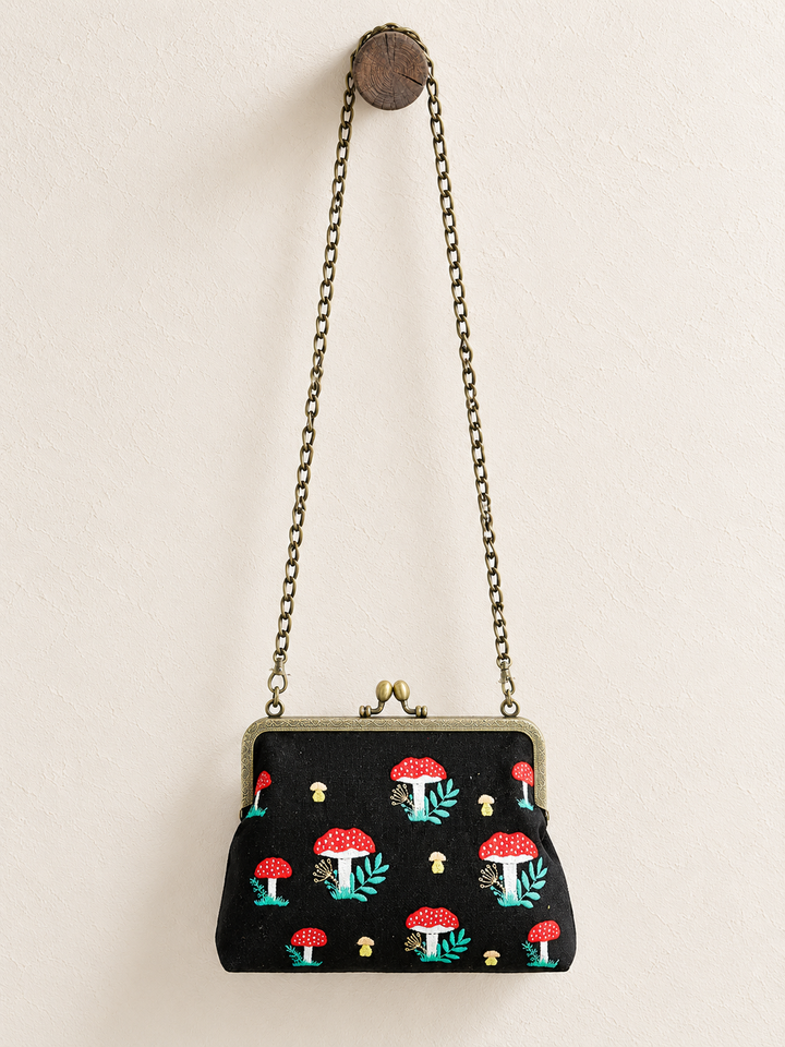 Mushroom Kisslock Bag hanging from long chain strap