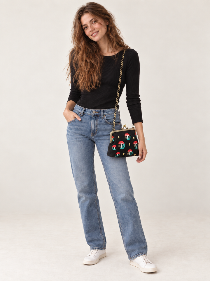 Model wearing Mushroom Kisslock Bag with chain strap at hip