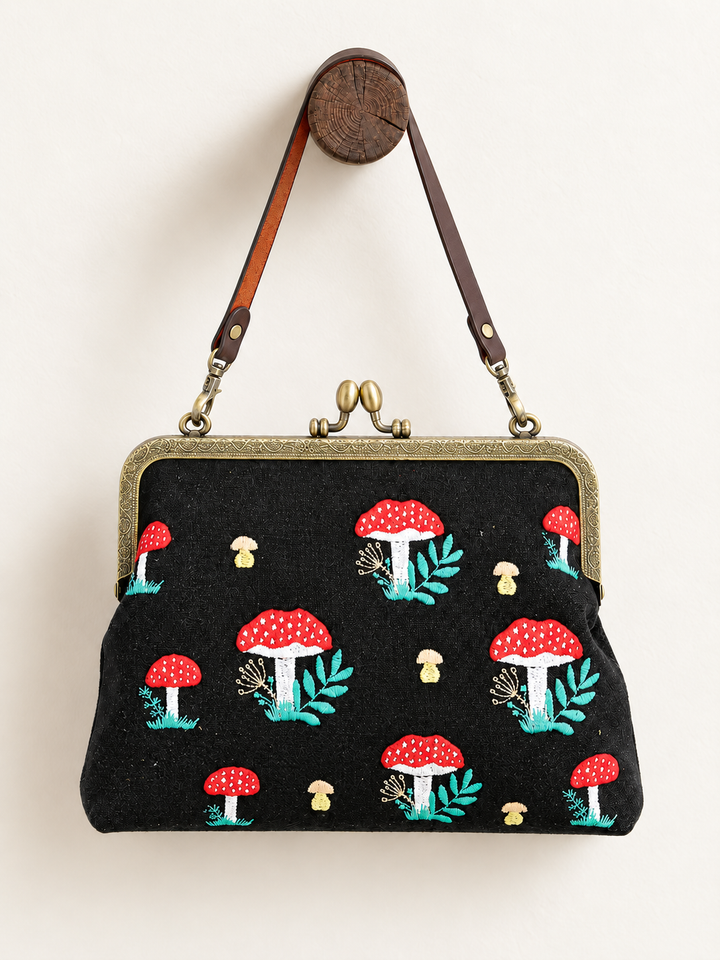 Mushroom Kisslock Bag hanging from short strap