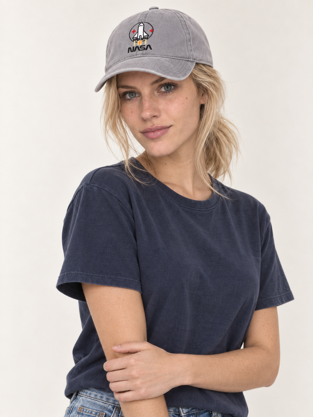 Model wearing gray NASA embroidered hat