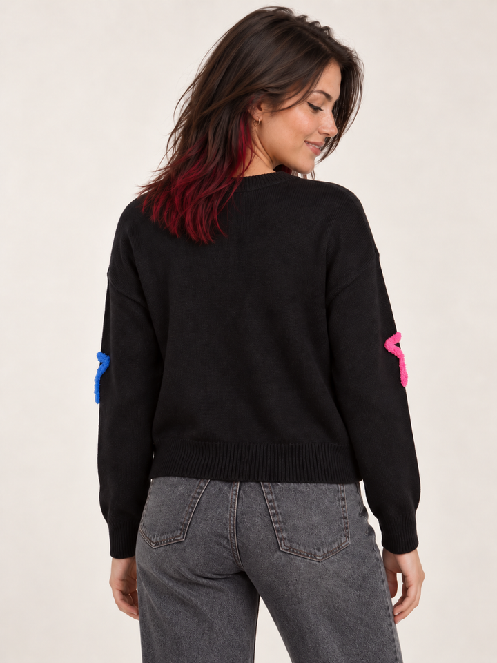 Model wearing Neon Fuzzy Star Sweater, back view